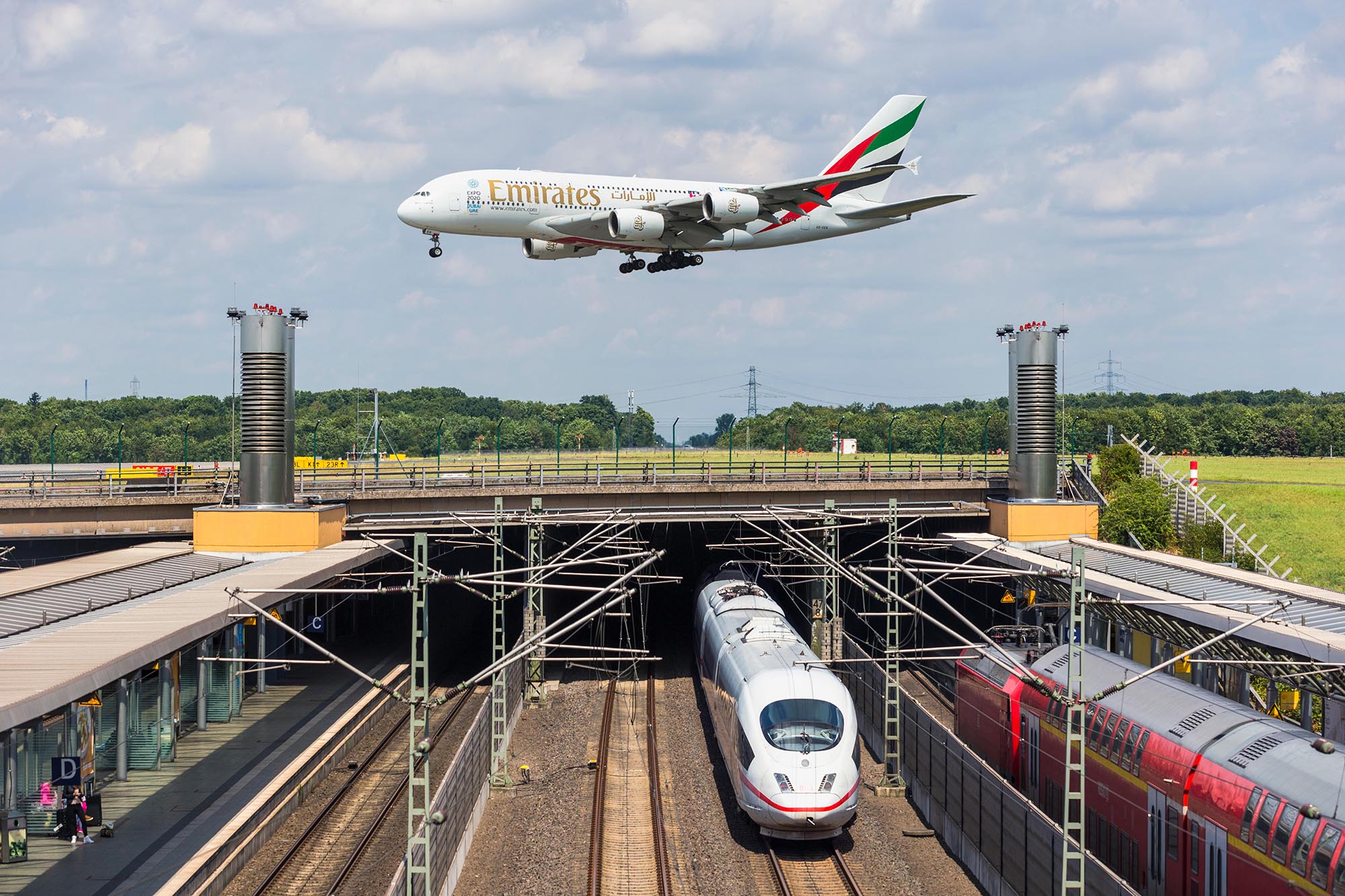 F04EXF Airbus A380 approaching runway Duesseldorf airport train station rail transport ICE international express train Germany Europe