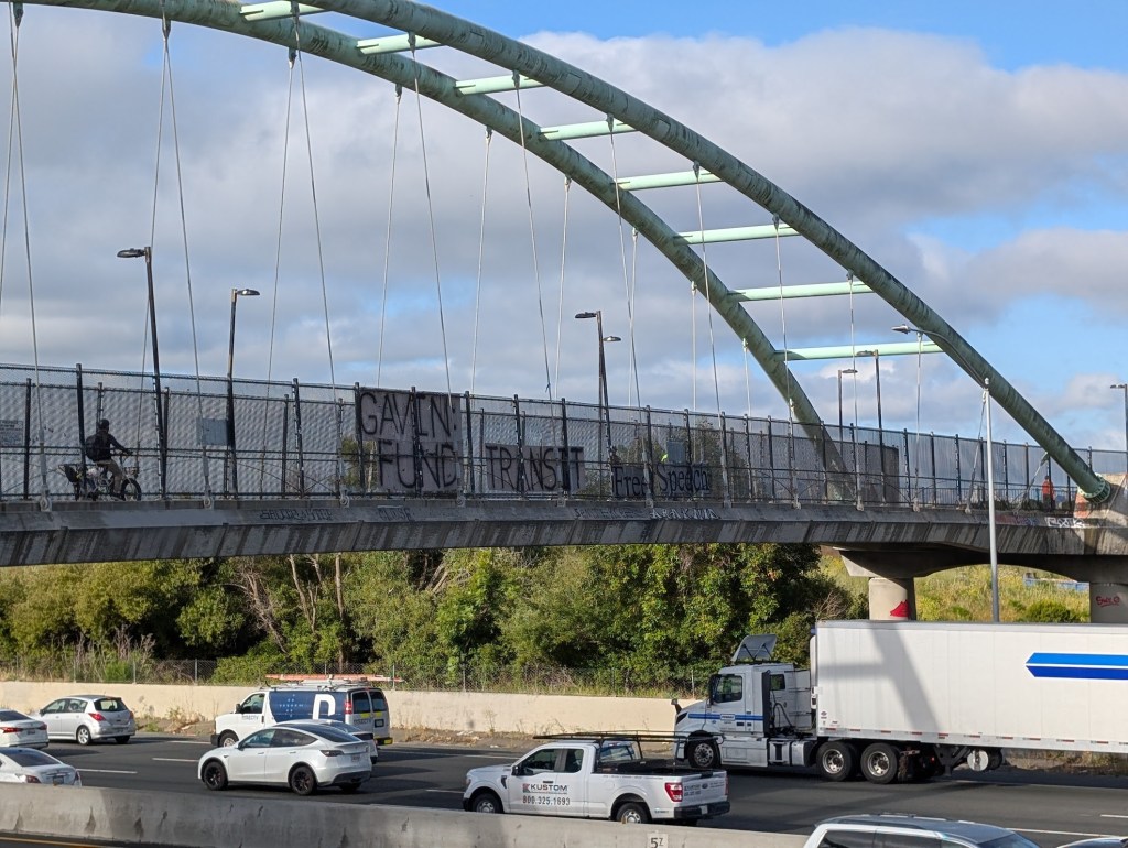 Banners Over Freeways Across the State Tell Newsom to Fund Transit
